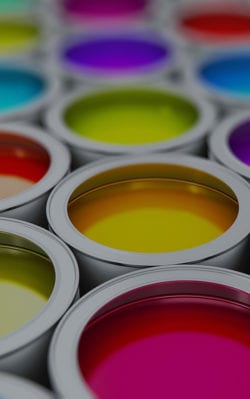 Gallon cans of colorful paint.