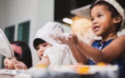 Youth children backing and offering to share ingredients.