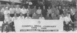 Group of Connell employees with a banner, Connell Bros. Company 1898-1998. "Looking towards the next hundred years.