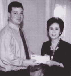 Mike Wilbur presented a check to a representative for the Princess of Thailand.