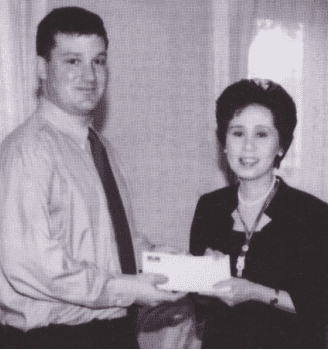 Mike Wilbur presented a check to a representative for the Princess of Thailand.