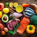 A rich mix of raw food ingredients displayed on a wooden table.