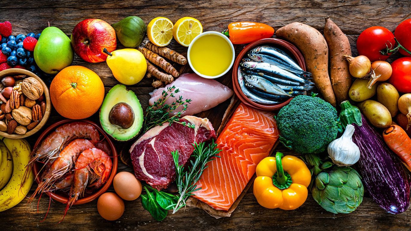 A rich mix of raw food ingredients displayed on a wooden table.