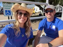 Two volunteers smiling at the camera