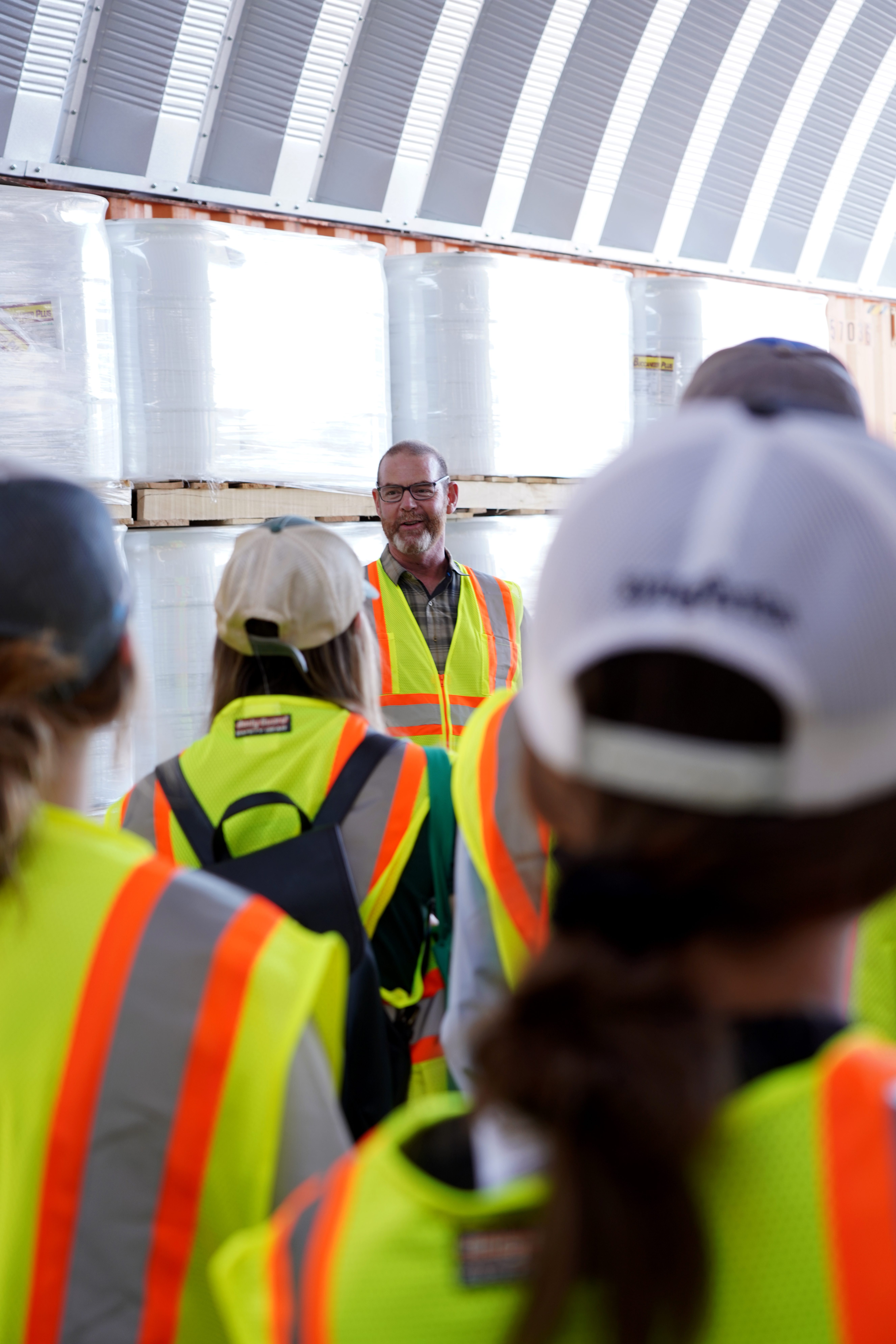 Supervisor talking to the team, all wearing saftey jackets