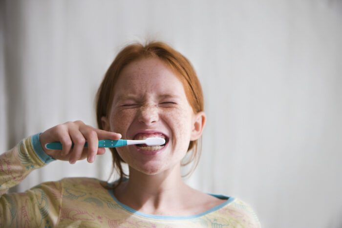 Young girl cleaning her teeth