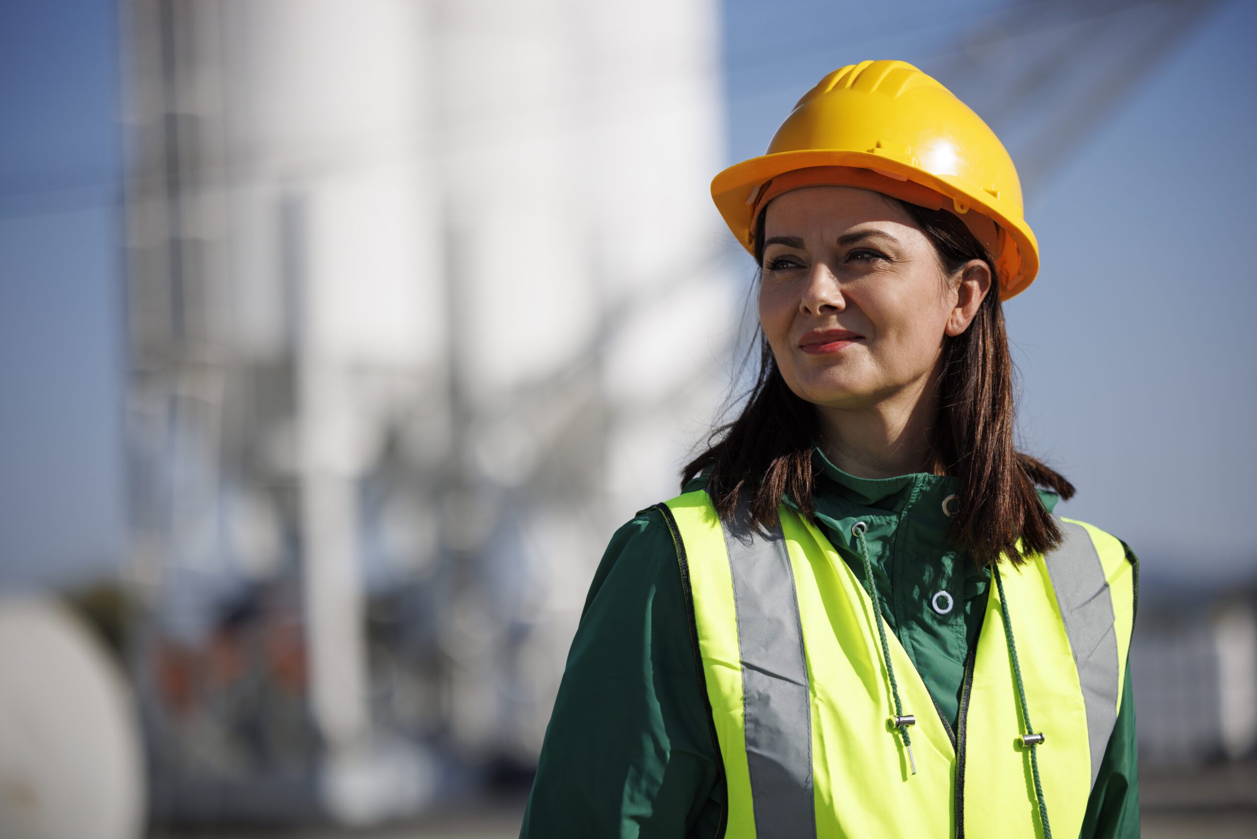 Portrait of female engineer with hardhat at factory industry workplace