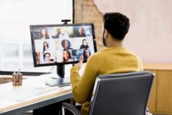 Young man participating in an online meeting.