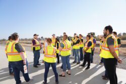 Workers in safety gear talking in a group