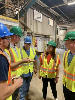 Workers in safety gear talking in a group
