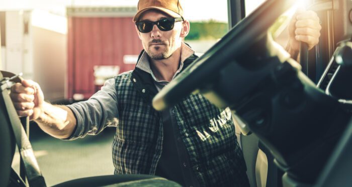 Semi Truck Driver and His Modern Truck Tractor. Getting Ready For the Next Destination.